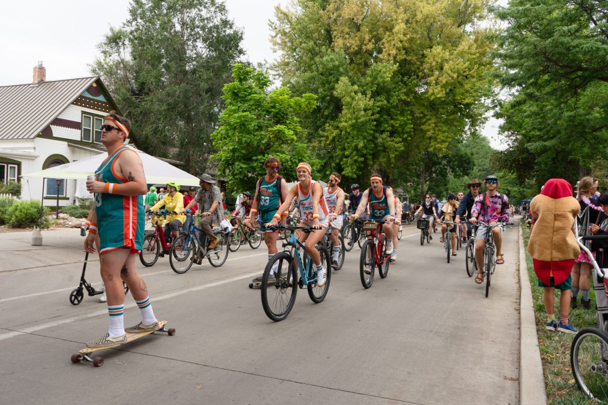 Fort Collins community members donning costumes, such as Flint Tropics retro basketball uniforms, bike down Mountain Avenue together in the Fort Collins Tour de Fat cycling parade Aug. 23.