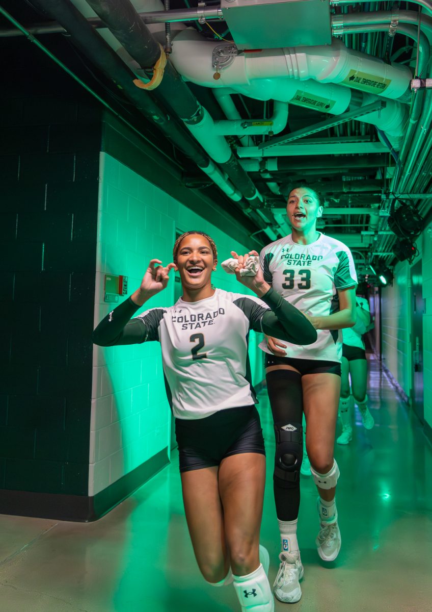 Sydney Black (2) and Kekua Richards (33) run down the halls of Moby Arena before running out to face the Colgate University Patriots Aug. 29. The Colorado State University volleyball team won 3-0.
