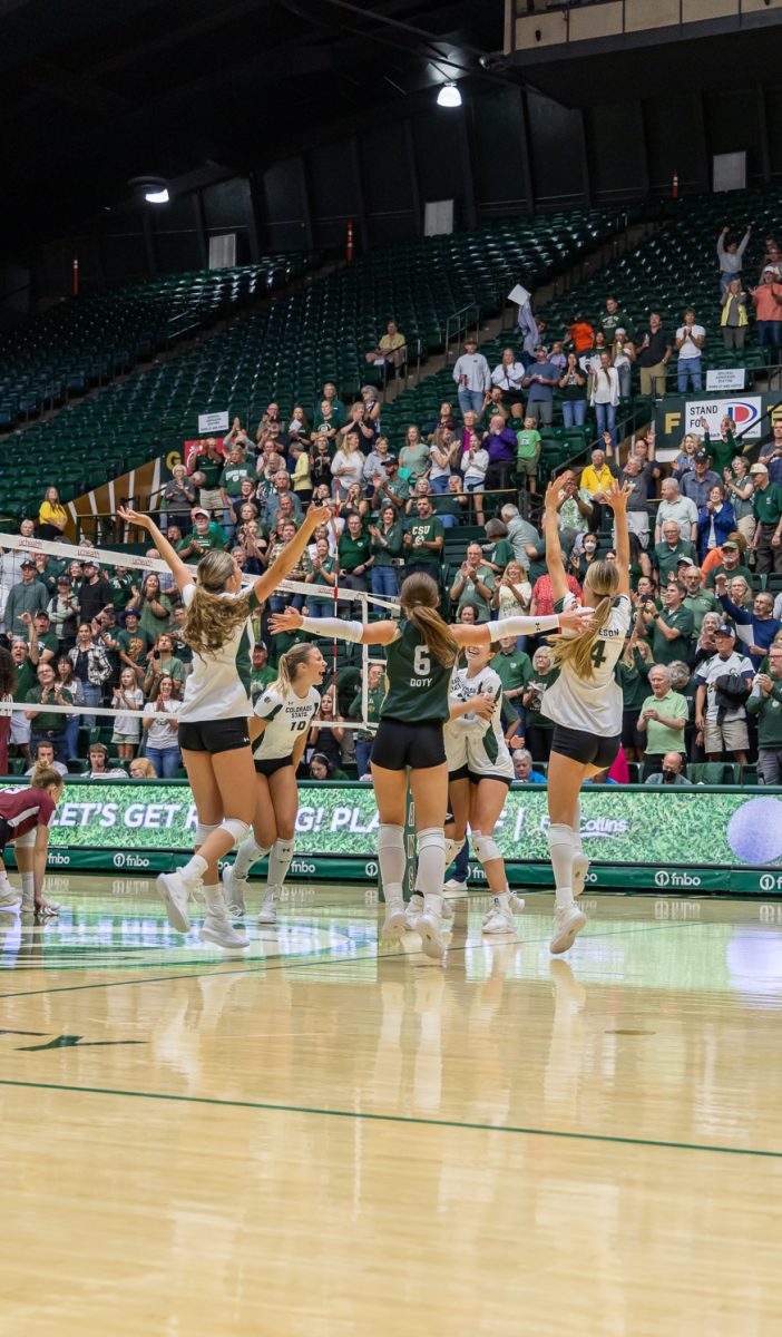 Colorado State University volleyball team cheers and jumps after their win against Colgate University in Moby Arena Aug. 29. CSU won 3-0.