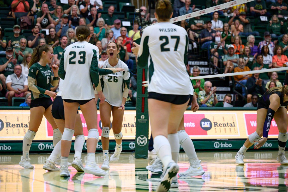 Outside hitter Maria Brun (26) celebrates a point with her teammates during Colorado State University's game against the University of Washington Aug. 30. CSU lost 2-3.