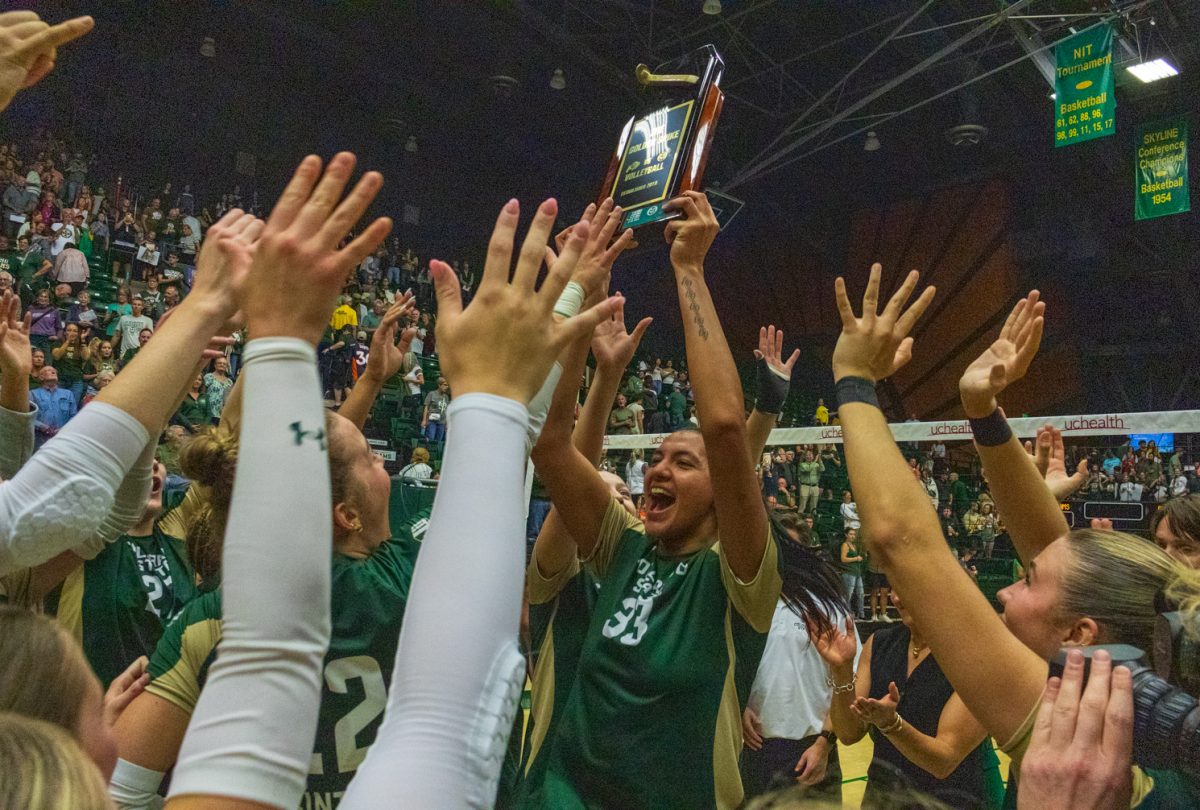 Colorado State middle blocker Kekua Richards (33) celebrates with teammates while holding the Golden Spike trophy after defeating Colorado in a volleyball match Sept. 17. CSU will hold the trophy till Friday where the winner for the next year will be determined, the Rams won 3-0. 