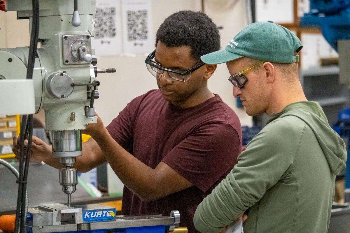 Students collaborate at a drill press during a workshop lab at the Engineering Manufacturing Education Center at Colorado State University Sept. 24.