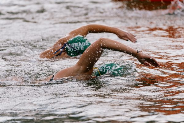 A pair of swimmers in a green Colorado State caps.