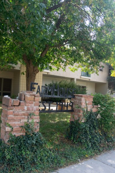 A building with a metal sign out front reading "FarmHouse."