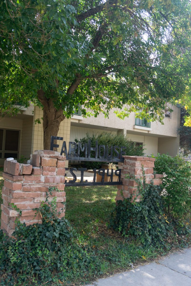 A building with a metal sign out front reading "FarmHouse."