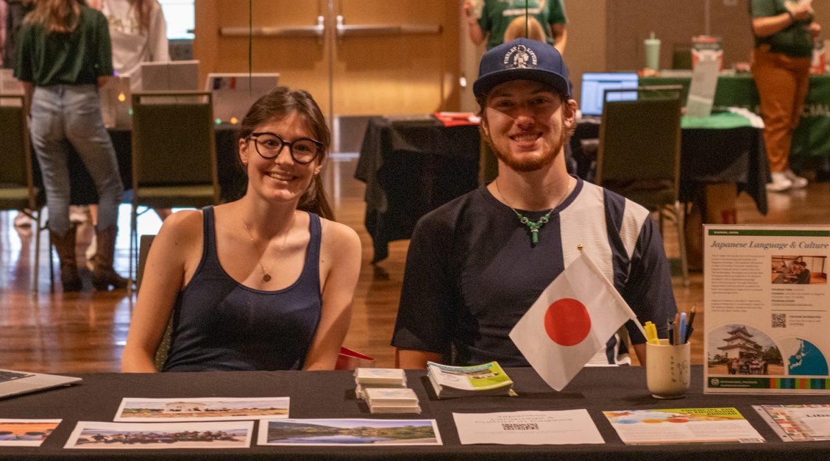 Delaney Roach , Left,  and Aaron Moore, Right, share their experiences at the Japan booth during the Education Abroad fair at the Lory Student Center ballroom at Colorado State University on Sept. 12, 2025. Moore said his speaking ability improved and that the culture and infrastructure made the experience "much more immersive." Roach said visiting shrines and cultural sites was the highlight "it was awesome to see the culture hands on rather than just a bird’s-eye view." Roach said.