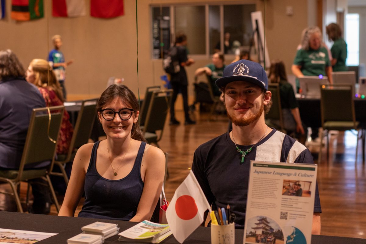Delaney Roach , Left,  and Aaron Moore, Right, share their experiences at the Japan booth during the Education Abroad fair at the Lory Student Center ballroom at Colorado State University on Sept. 12, 2025. Moore said his speaking ability improved and that the culture and infrastructure made the experience "much more immersive." Roach said visiting shrines and cultural sites was the highlight "it was awesome to see the culture hands on rather than just a bird’s-eye view." Roach said.