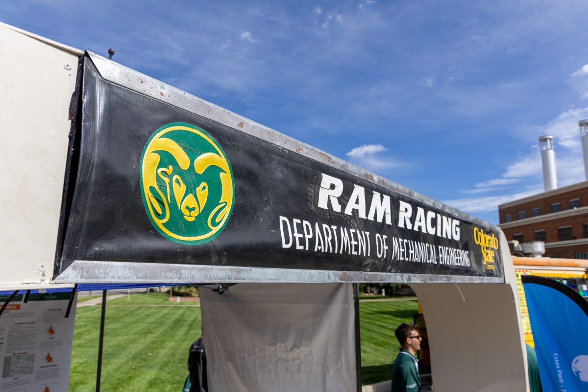 A booth at an event has a sign that reads "Ram Racing, Department of Mechanical Engineering"