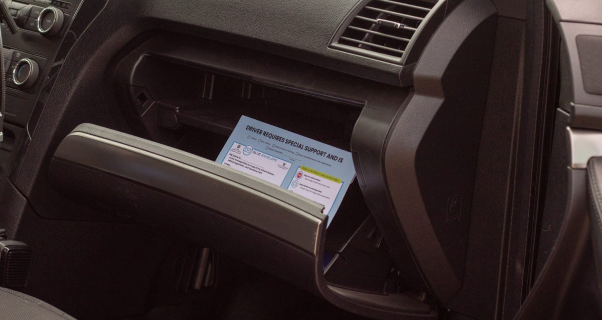 A blue envelope sits inside the glove box of a vehicle on Colorado State University's campus Sept. 16.