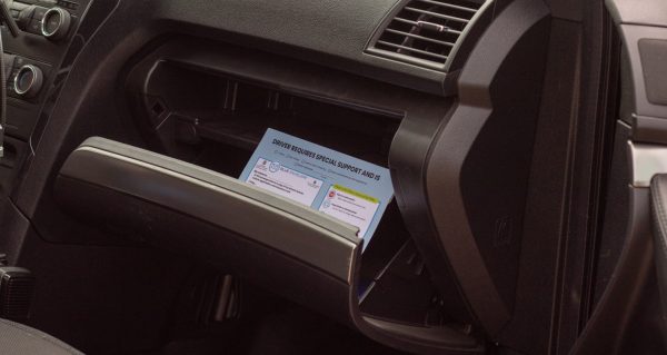 A blue envelope sits inside the glove box of a vehicle on Colorado State University's campus Sept. 16.