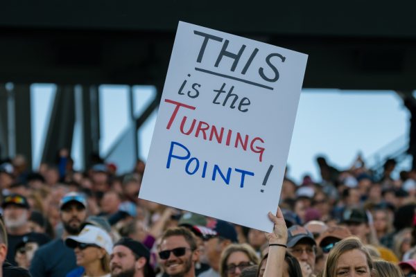 A sign held up with the words 'This is the Turning Point!'.