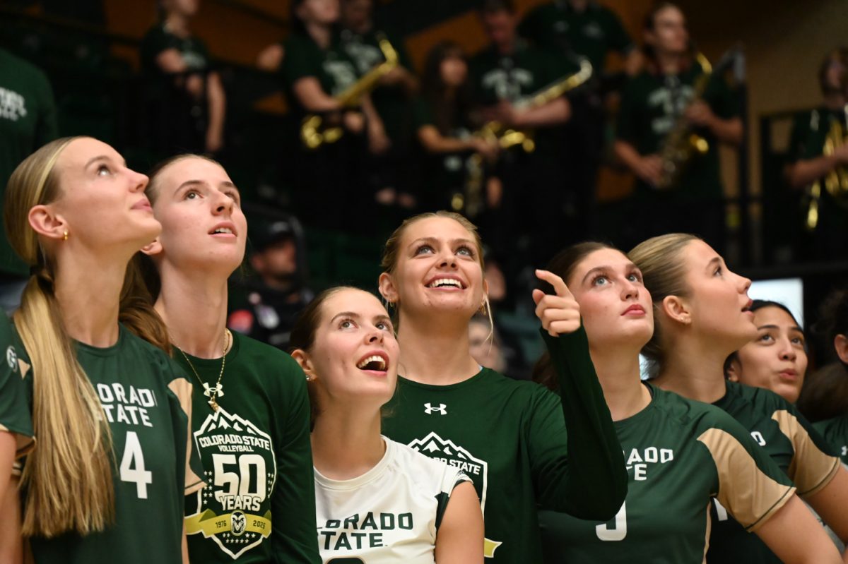 Players for Colorado State University watch as the two new championship banners — one for winning the regular season and the other for winning the Mountain West Championship — are unveiled during the rivalry game against Colorado Sept. 18. CSU won 3-0.