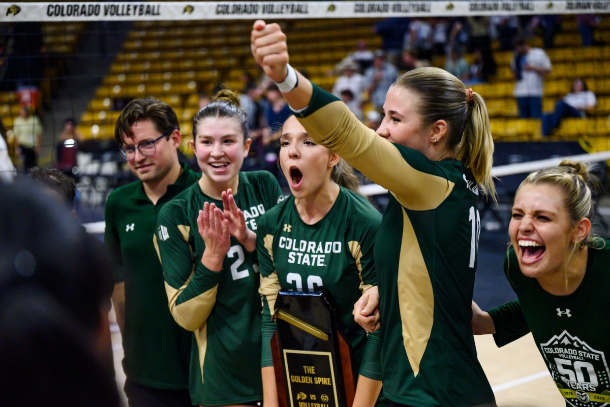 Colorado State University volleyball players 
Erin Debiec (23), Maria Brun (26) and Brenna Rowland (10) cheer with their team after winning the Golden Spike trophy from the University of Colorado Sept. 19. CSU 3-1.
