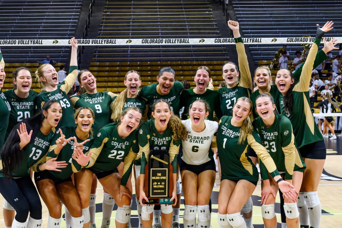 Colorado State University's volleyball team poses for a photo with the Golden Spike trophy after winning their second match against the University of Colorado Sept. 19. CSU won 3-1.