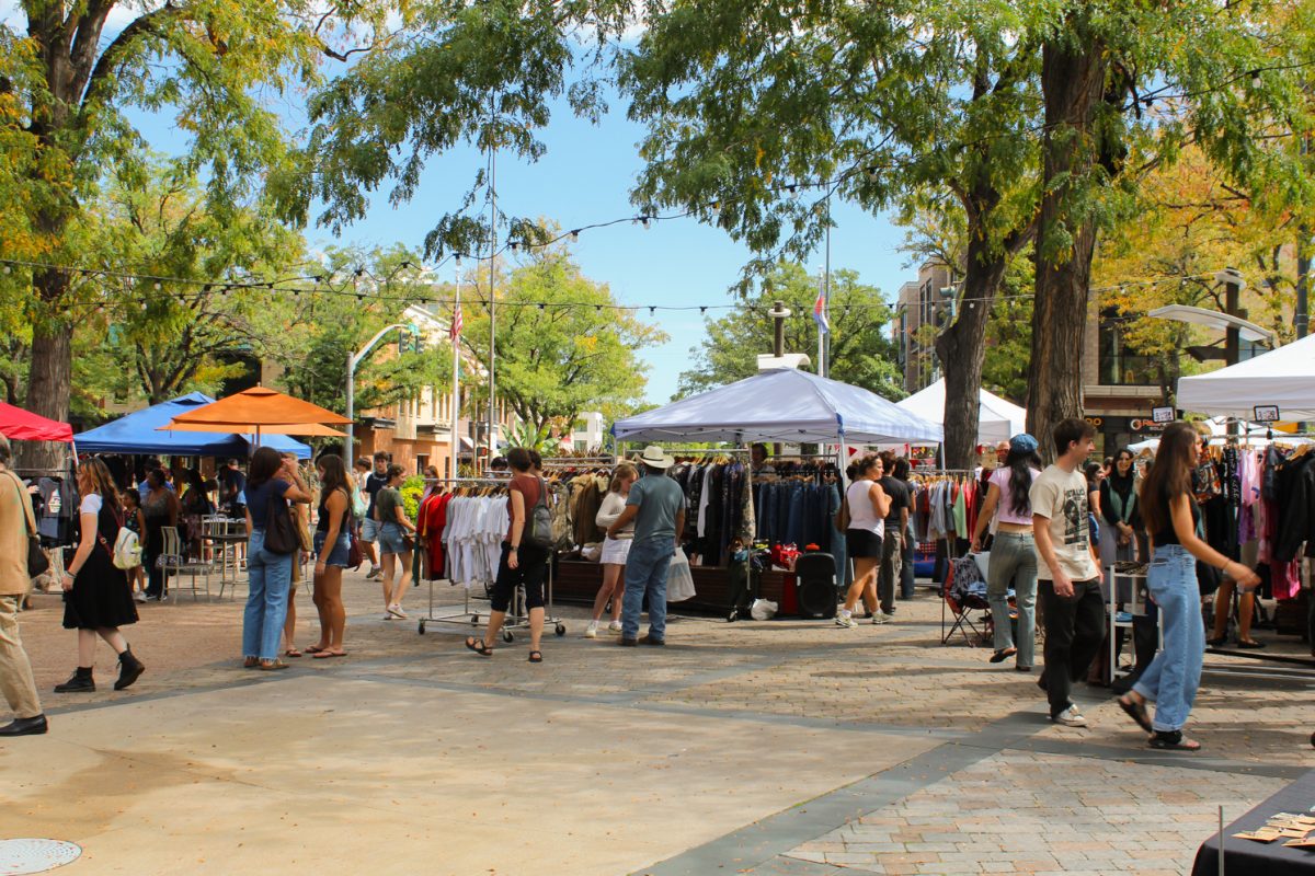 Shoppers browse the Vintage Market booths set up on the Oak Street Plaza in Old Town Sept. 20.