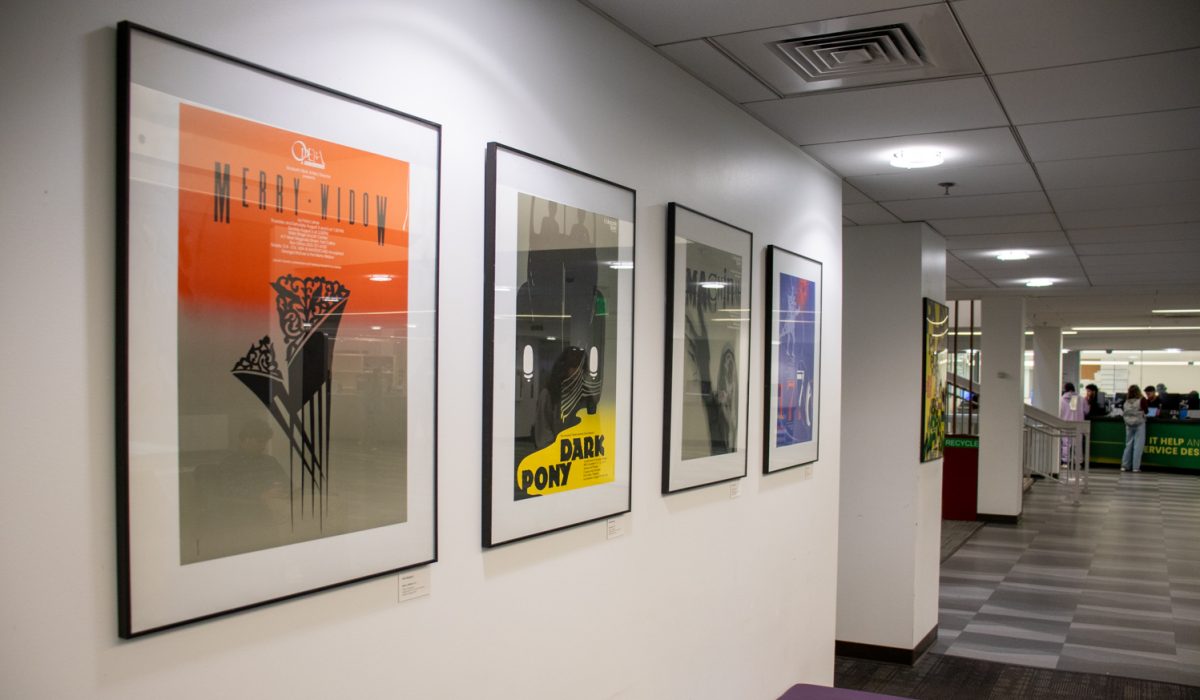 five posters showing Paul Risbecks work hang on display.