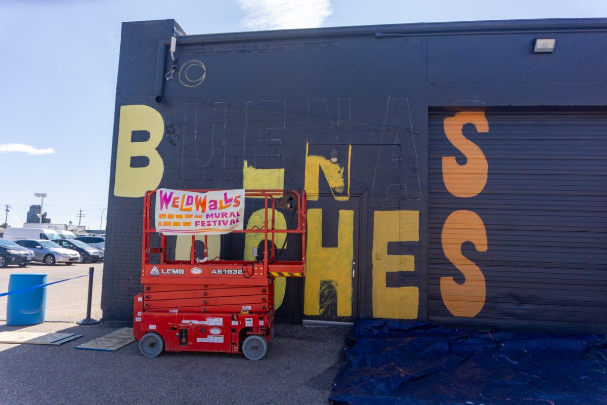 A mural with the words "Buenas Noches" is in progress during WeldWalls Mural Festival in Greeley Sept 20. Weld Walls brings together artists to create publicly accessible murals, according to the website. The event includes artist talks, workshops, mural unveilings, and a community celebration.