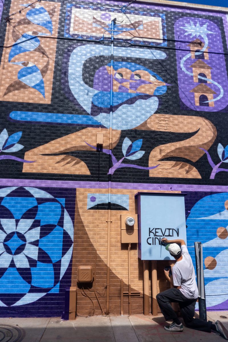 Kevin Cincotta adds his name to his mural during WeldWalls Mural Festival in Greeley Sept 20. "This mural is meant to feel open," Cincotta said in the mural description. "...viewers can bring their own memories and experiences to it."
