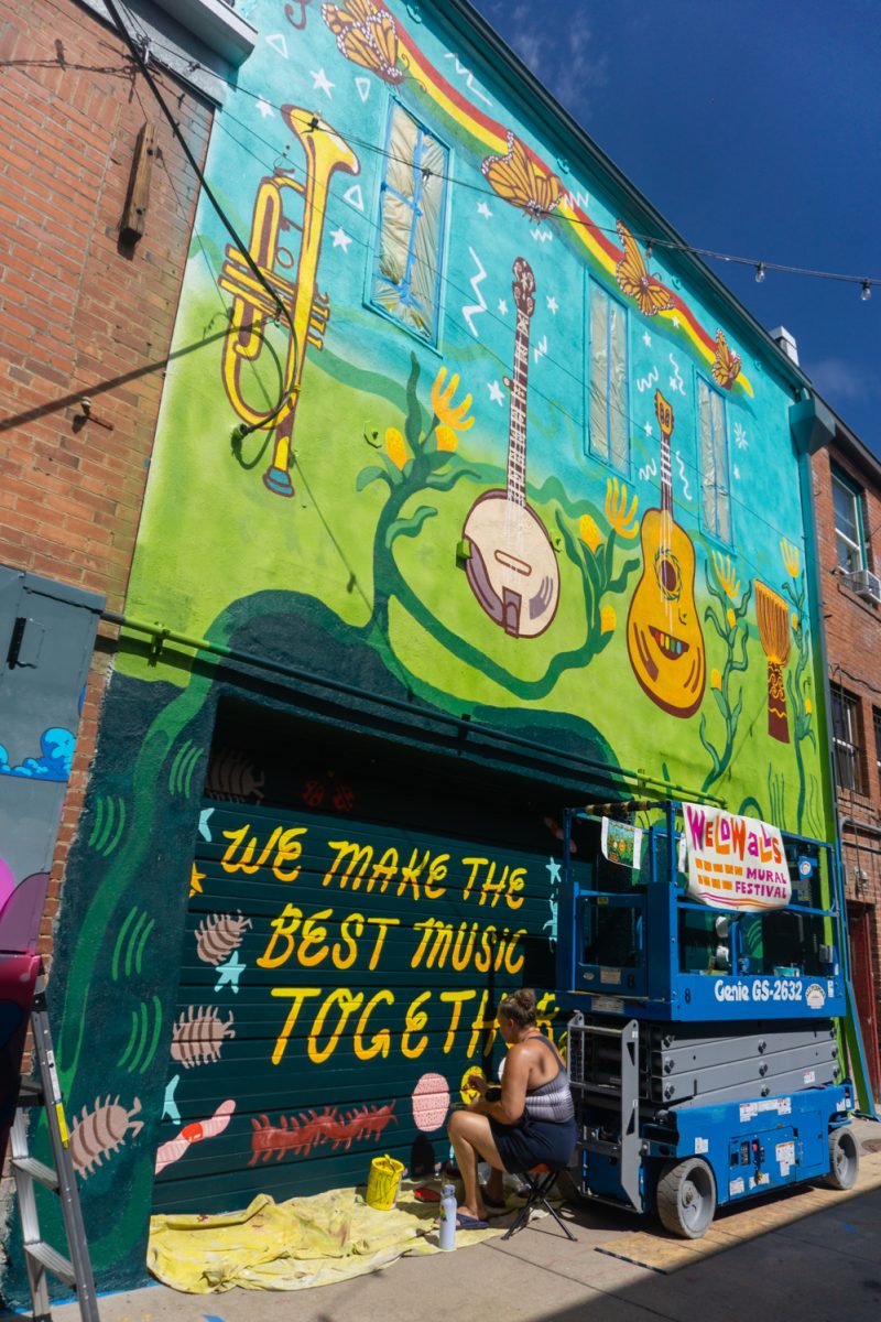 Members of Blackbox Art Collective work on their mural during WeldWalls Mural Festival in Greeley Sept 20. Weld Walls brings together artists to create publicly accessible murals, according to the website. The event includes artist talks, workshops, mural unveilings, and a community celebration.
