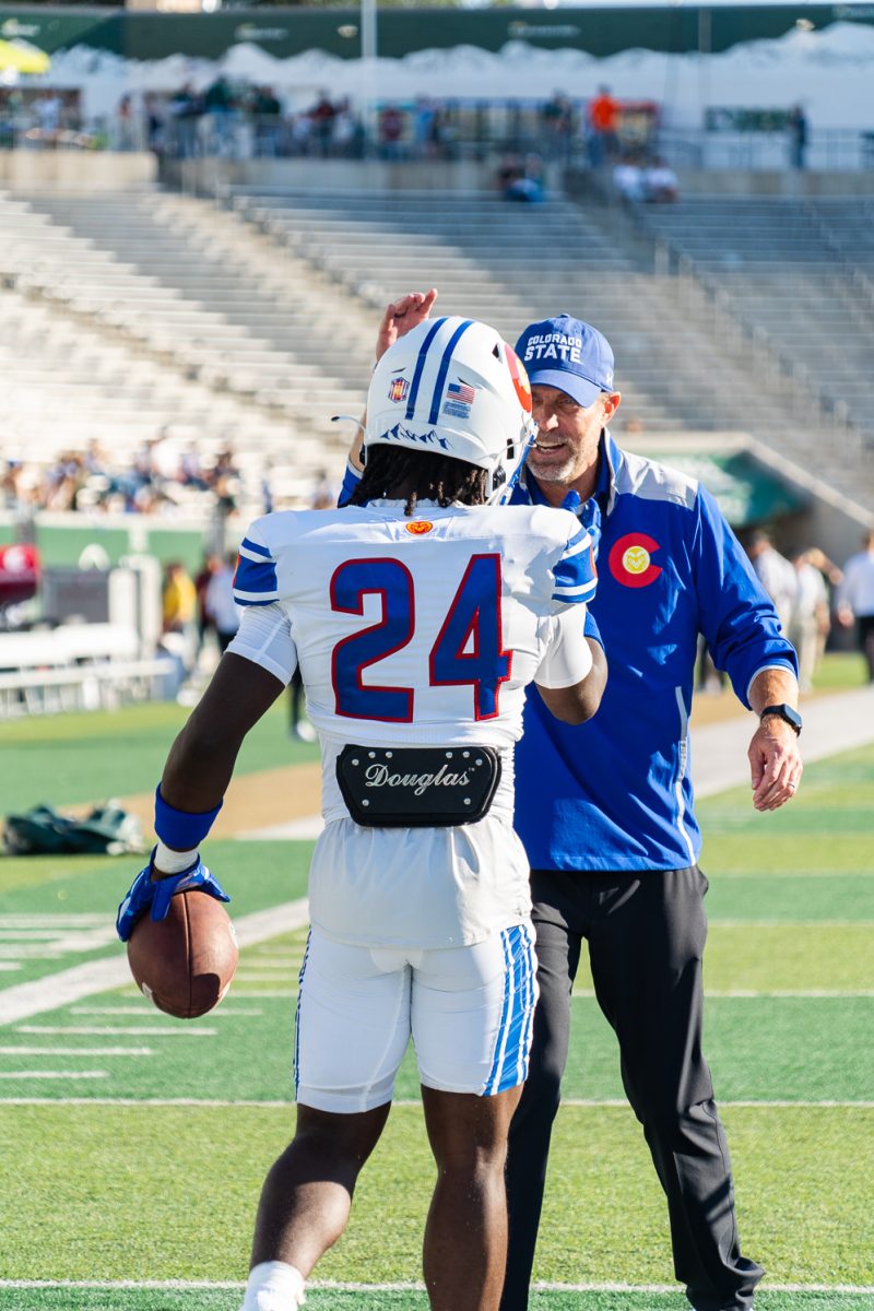 Colorado State University running back Javion Kinnard (24) talks to associate head coach Matt Mumme after catching a pass during warm-ups before the game against Washington State University Sept. 27. 