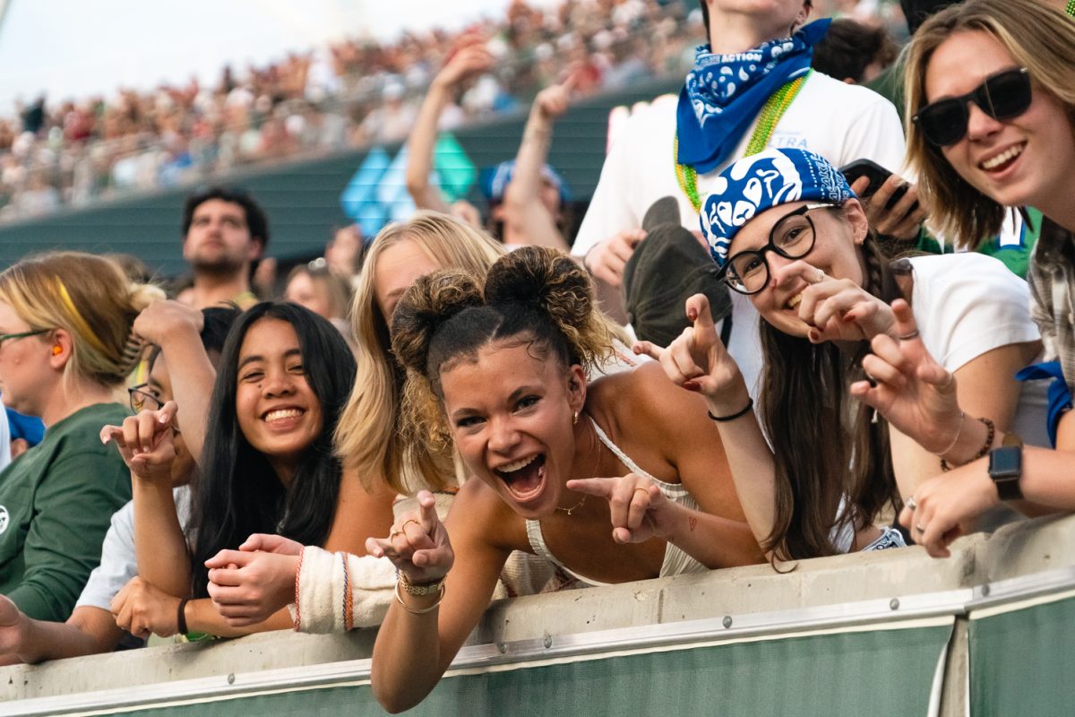 Students cheer on the Rams in the student section at Canvas Stadium during the Colorado State football game against Washington State Sept. 27. Students wore white and blue to celebrate the State Pride game.