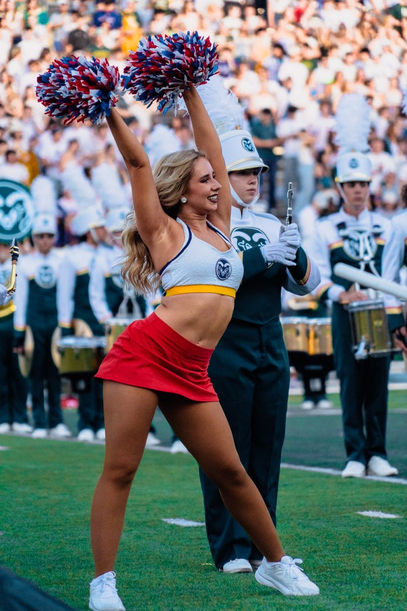 Colorado State University Golden Pom dancer Elizabeth Potter performs alongside the marching band as the Rams prepare to take the field before their football game against Washington State University Sept. 27. 
