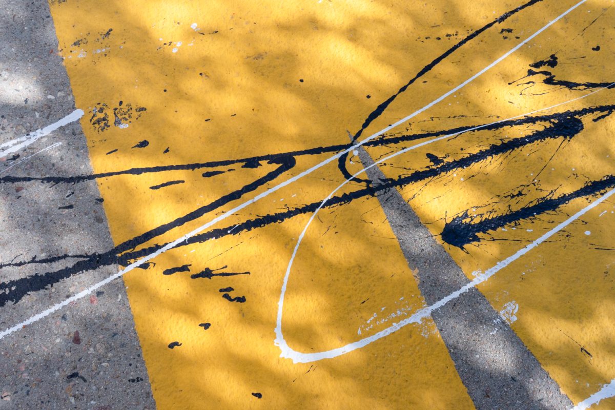 Black and white paint is splattered onto a large-scale yellow “Black Lives Matter” mural on the ground outside of the Visual Arts building at Colorado State University Sep. 27.