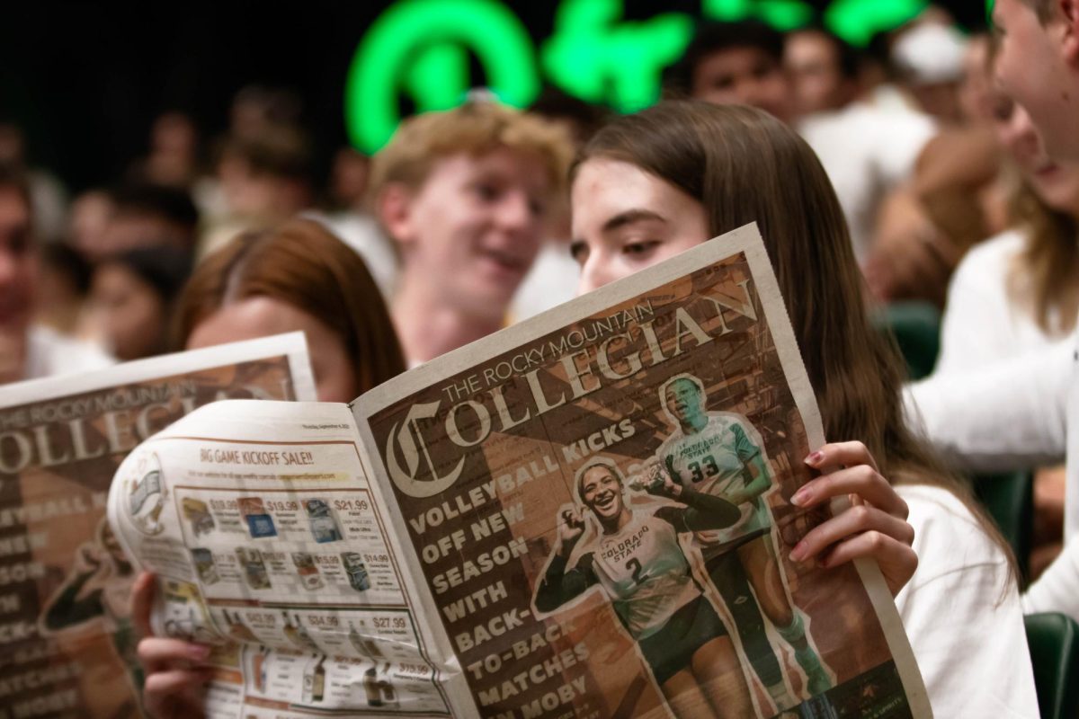 Students read the Rocky Mountain Collegian Newspaper at the Colorado State University's volleyball game on Friday Sept. 12th at Moby Arena, in Fort Collins Colorado. Photo taken by Erica Pickering.