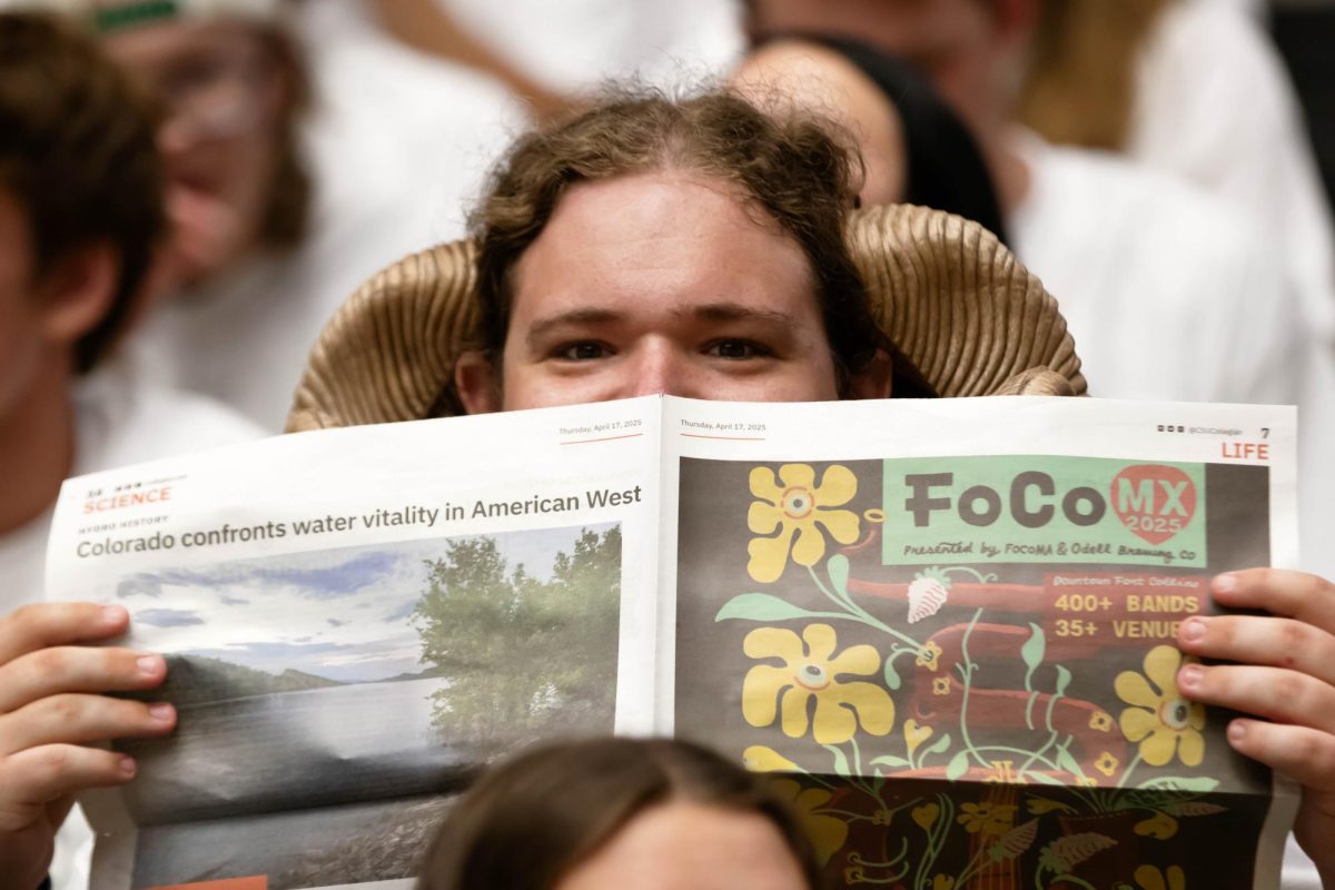 Studentsdive into the Rocky Mountain Collegian Newspaper at the Colorado State University's volleyball game on Friday Sept. 12th at Moby Arena, in Fort Collins Colorado. Photo taken by Erica Pickering.