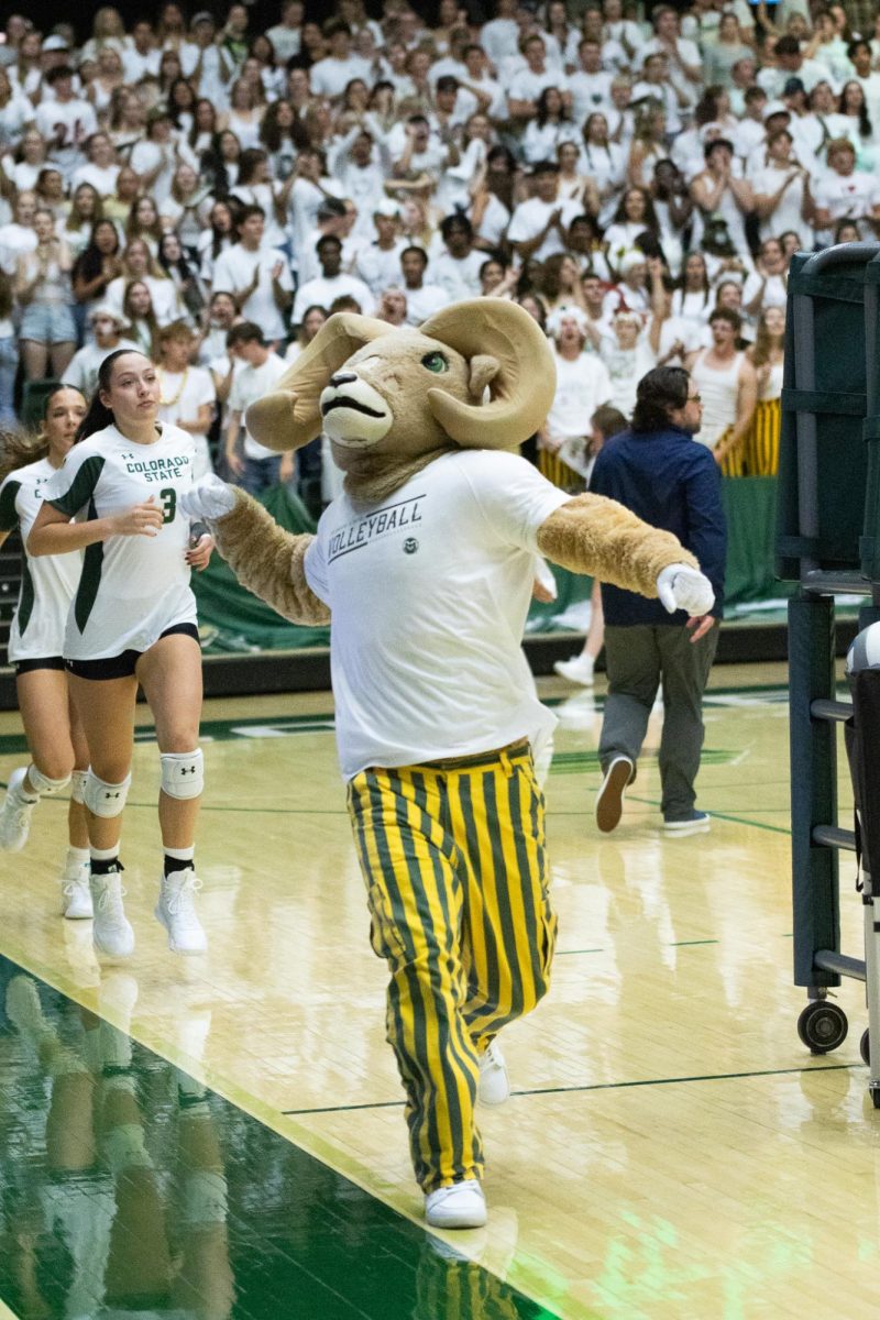 School Mascot Cam the Ram runs onto the court cheering and hyping up the crowd.