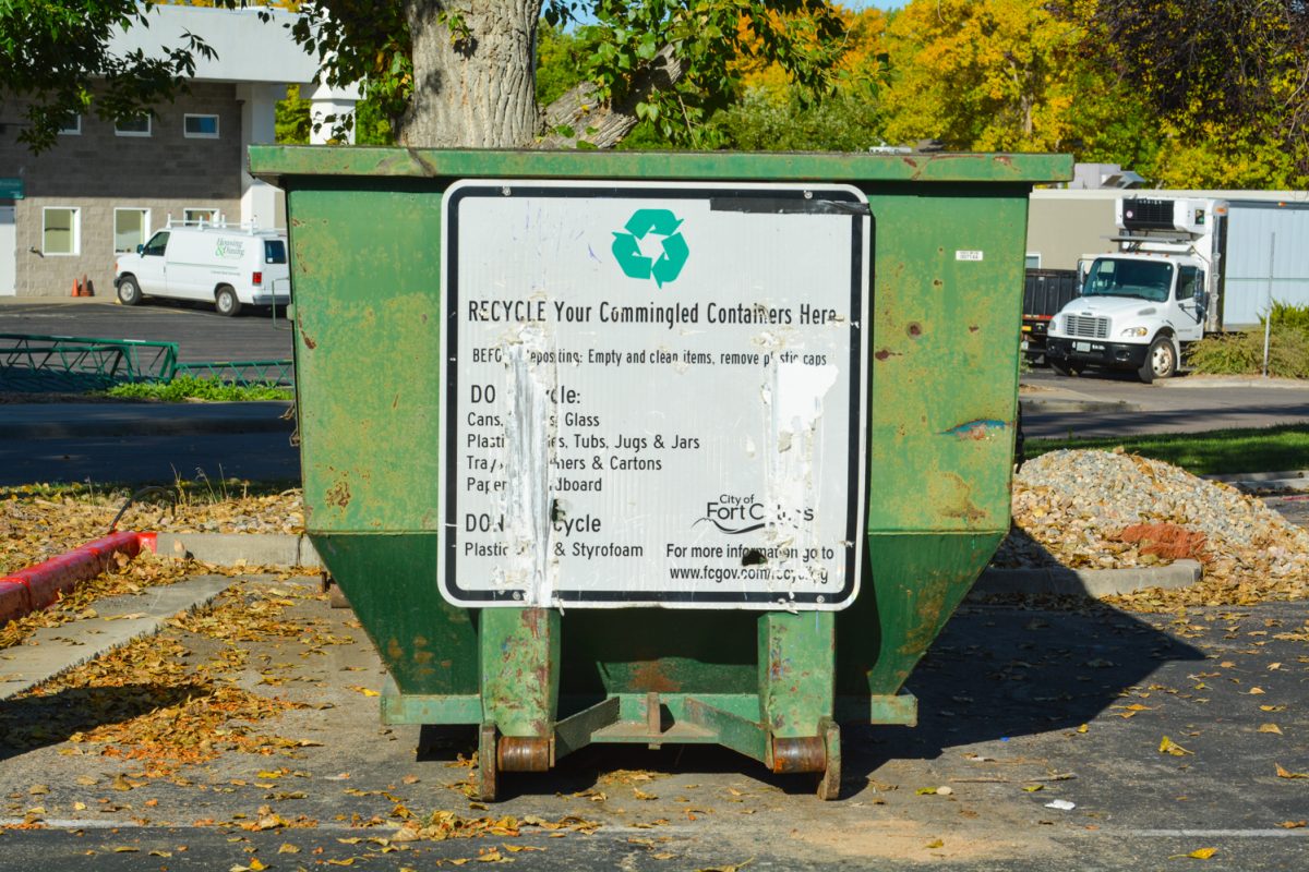 A green recycling container with instructions on it.