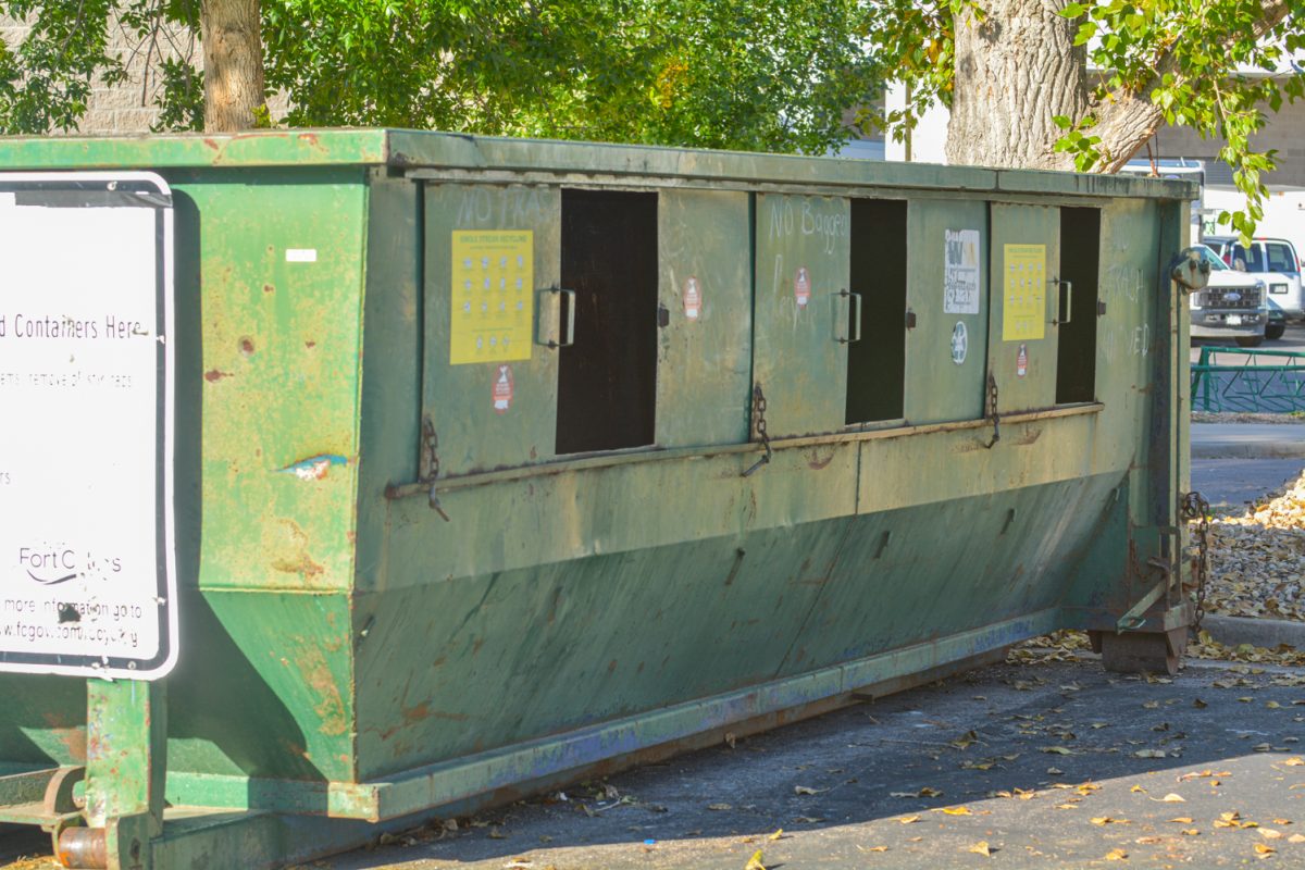 A green recycling container.