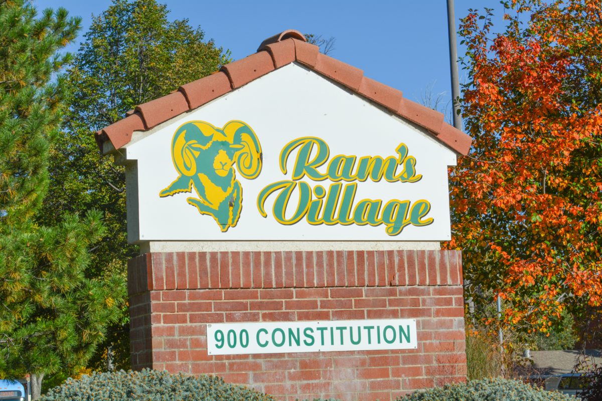 A green and white sign that states "Ram's Village"