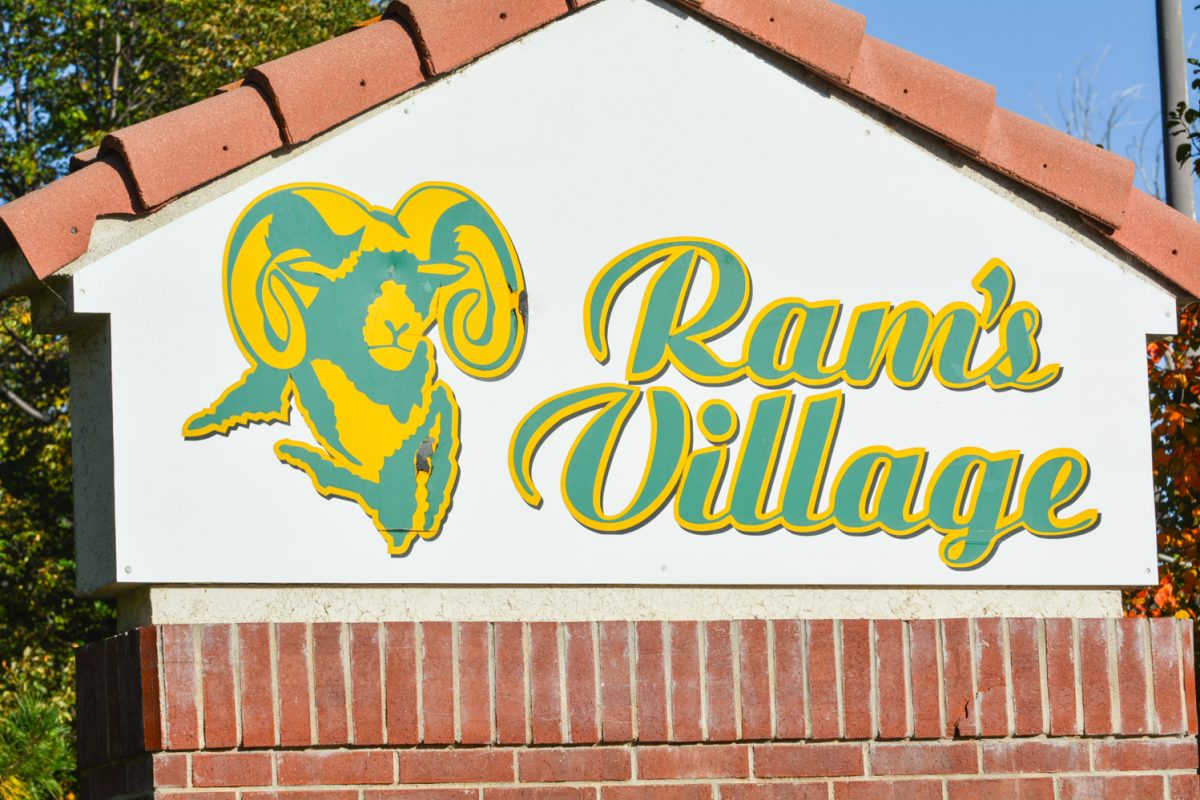 A green and white sign that states "Ram's Village"