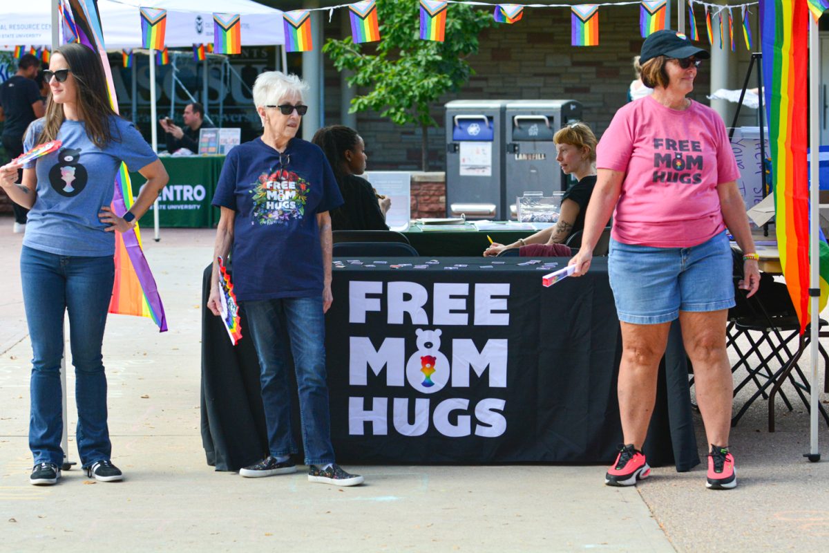 Three ladies standing in front of a booth.