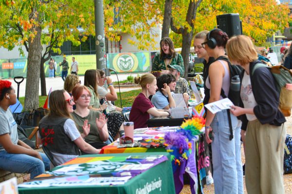 A group of people talking to people at booths.
