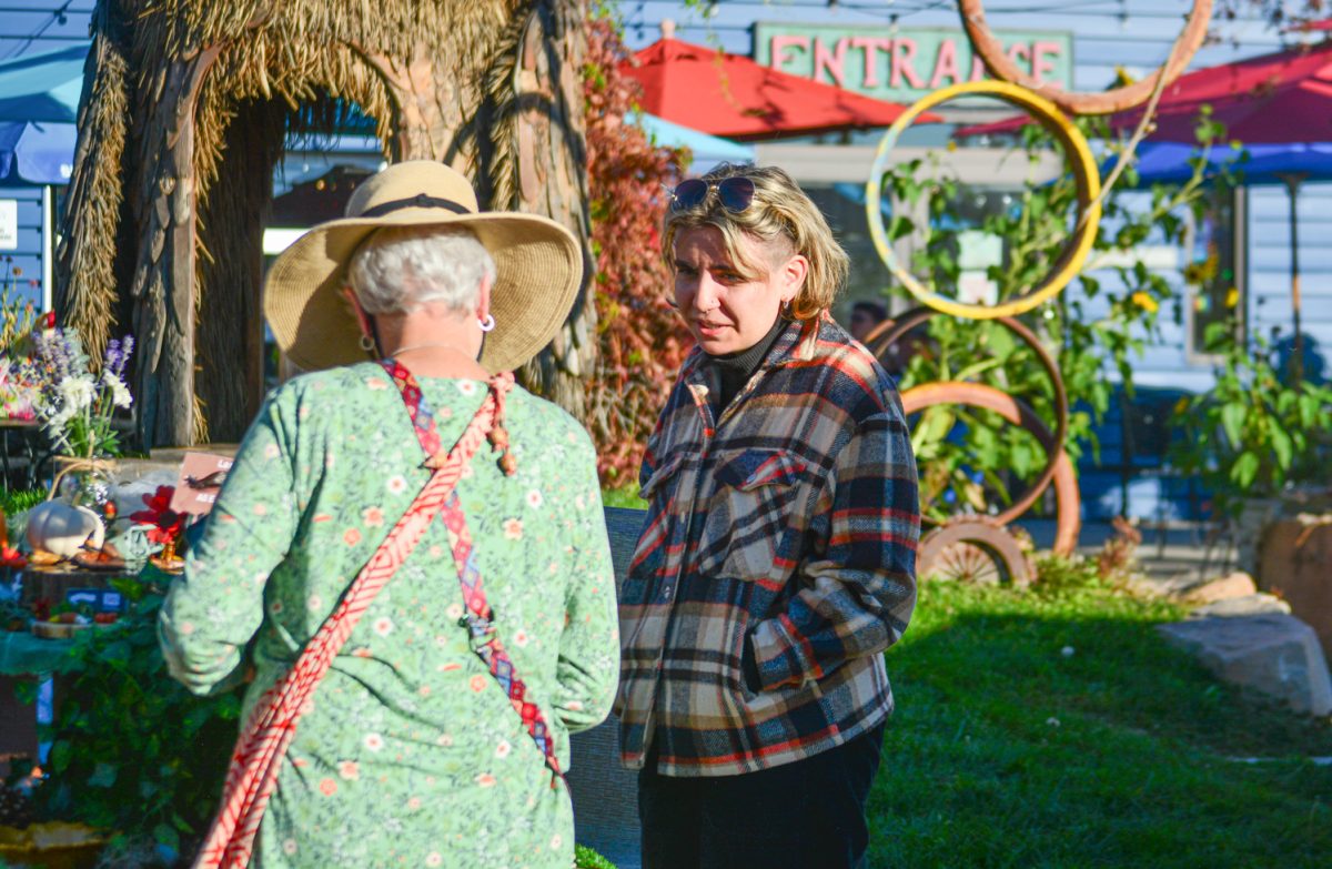 Lex Lupton describing her art pieces to a customer Oct. 19. "Im a visual artists and I make polymer oven baked clay work" Lex states "My specialty is making slugs and snails but what I really love is just kind of like celebrating the unloved."