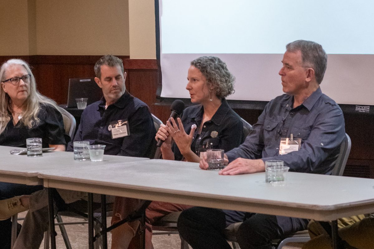 Stephen Shachtman, Allie Ogg, Gregory Fields, and Todd Kundla sit on a panel during an artist panel discussion Oct 10. "I like to always create joy for people, for the environment," Ogg said. "I love that the way that a mural, especially on the transformer boxes or on a plain wall, used to be something that no one looked at as visible, and it becomes something that makes people smile, want to take pictures in front of, becomes something that they're proud of in their community."
