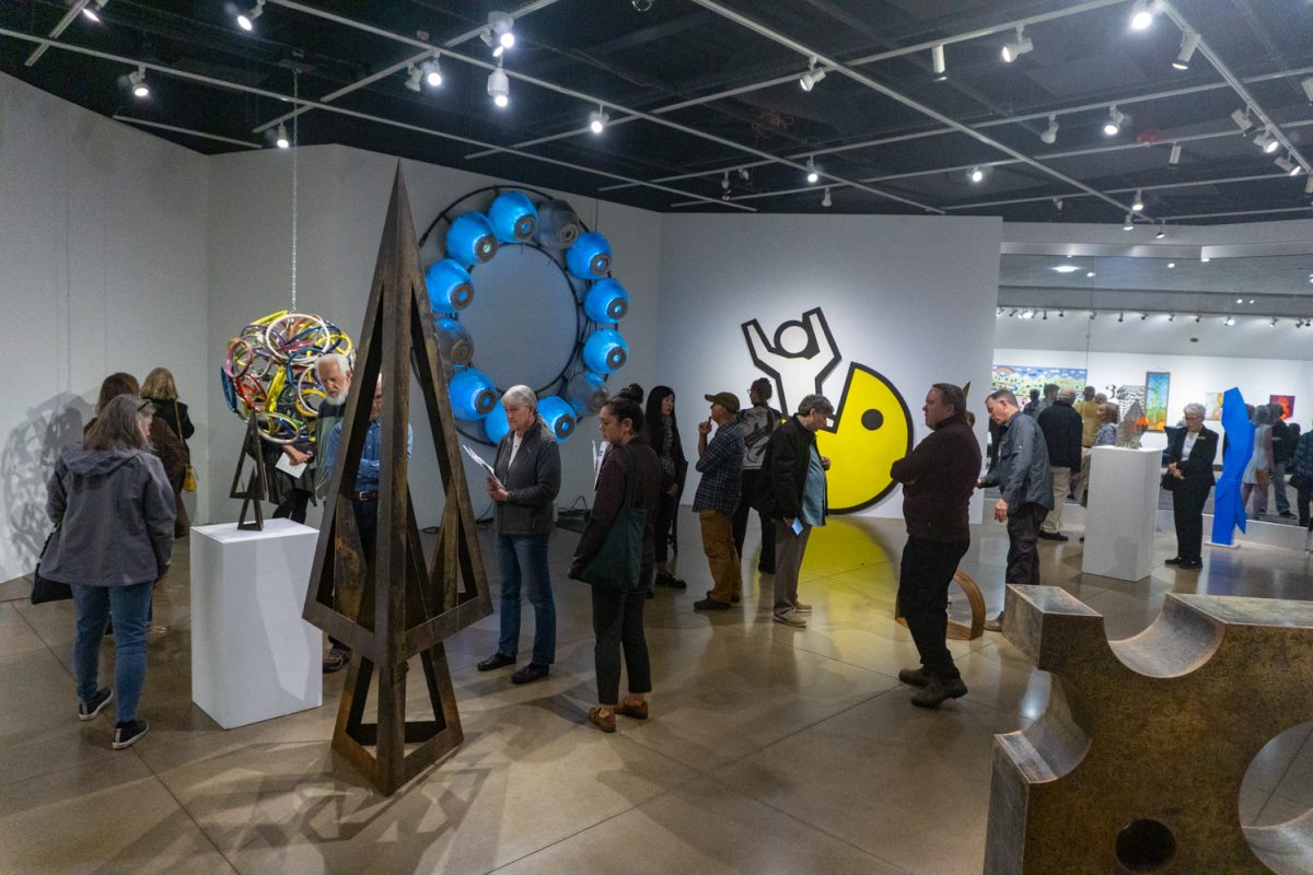 Guests view art on display at The Lincoln Center Gallery Oct 10. The art gallery showcases the personal artwork of six artists who are creating art to enrich local public spaces.