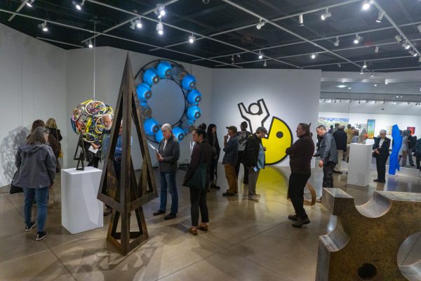 Guests view art on display at The Lincoln Center Gallery Oct 10. The art gallery showcases the personal artwork of six artists who are creating art to enrich local public spaces.