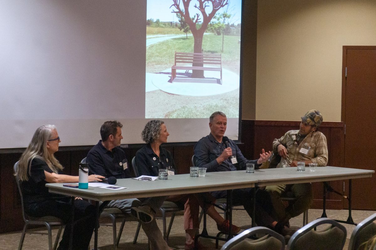 Stephen Shachtman, Allie Ogg, Gregory Fields, and Todd Kundla sit on a panel during an artist panel discussion Oct 10. "I like to always create joy for people, for the environment," Ogg said. "I love that the way that a mural, especially on the transformer boxes or on a plain wall, used to be something that no one looked at as visible, and it becomes something that makes people smile, want to take pictures in front of, becomes something that they're proud of in their community."