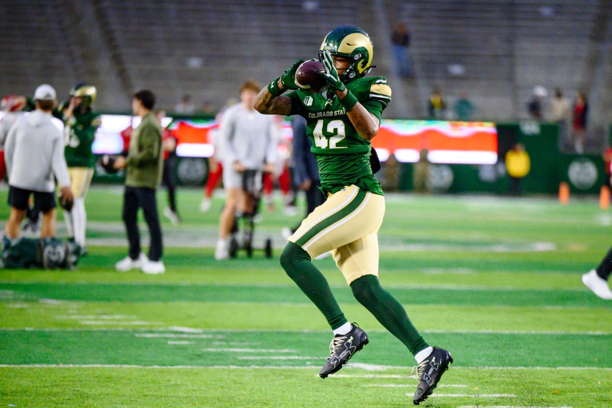 Colorado State University tight end Jaden Landrum (42)  catches a ball thrown by a coach as the team warms up for CSU's game against Fresno State University Oct. 10.