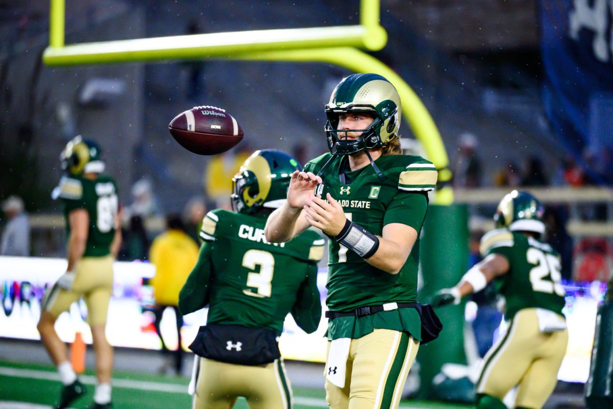 Colorado State University quarterback Jackson Brousseau (7) recieves a new ball from a coach during warmups before CSU's game against Fresno State University Oct. 10.