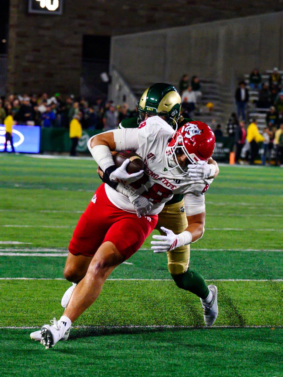 A Colorado State University football player takes down Fresno State University football player Richie Anderson III (88) during CSU's game aginst FSU Oct. 10.