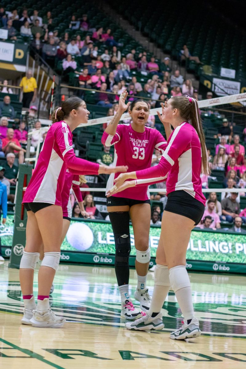 Kekua Richards (33) celebrates a point with her teammates during Colorado State University's game against Utah State University Oct 11.