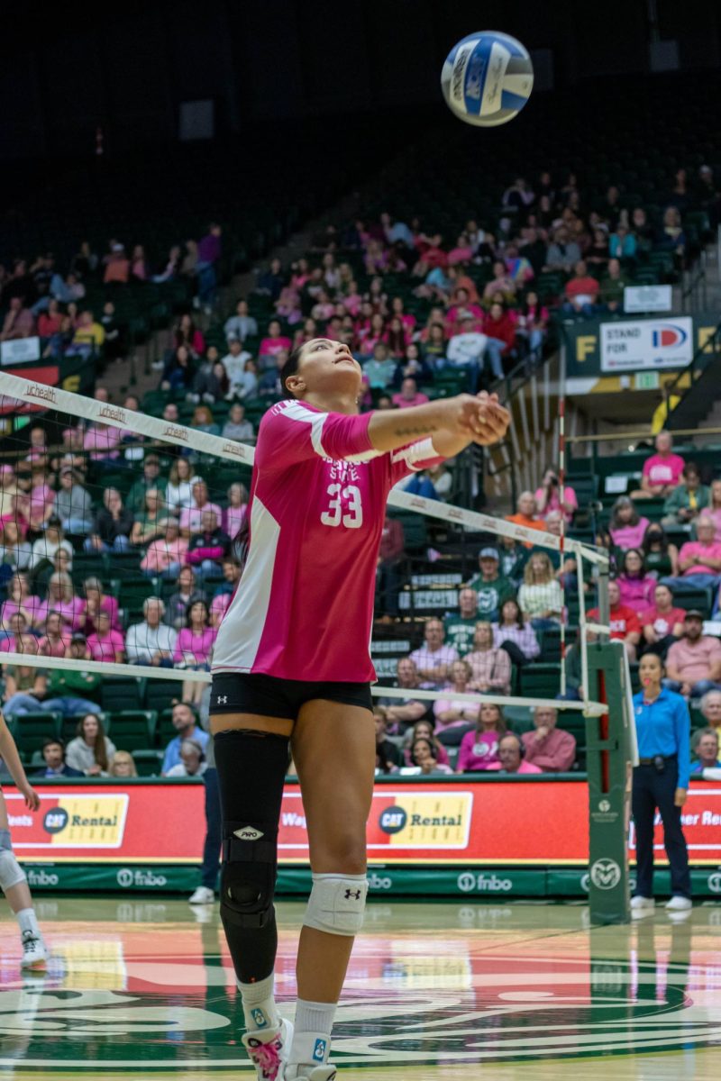 Kekua Richards (33) bumps the ball over the net during Colorado State University's pink out game against Utah State University Oct 11.