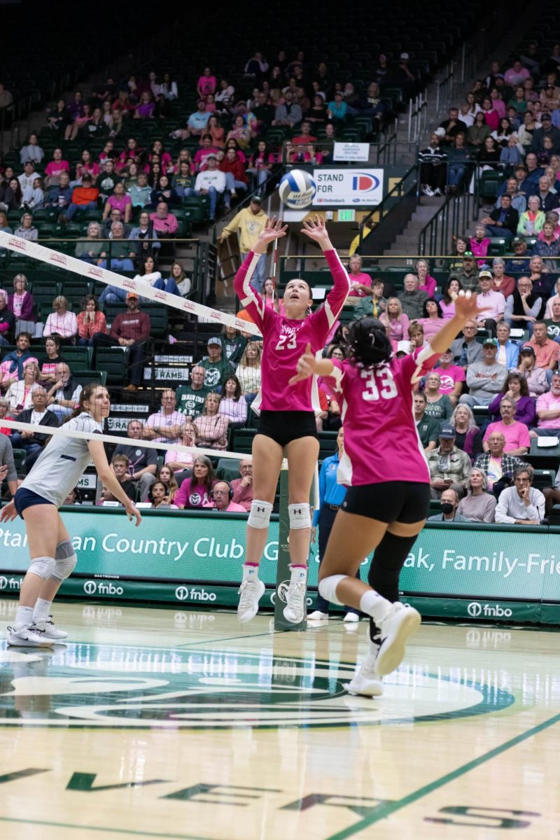Erin Debiec (23) sets the ball for Kekua Richards (33) during Colorado State University's game against Utah State University in Moby Arena Oct 11.