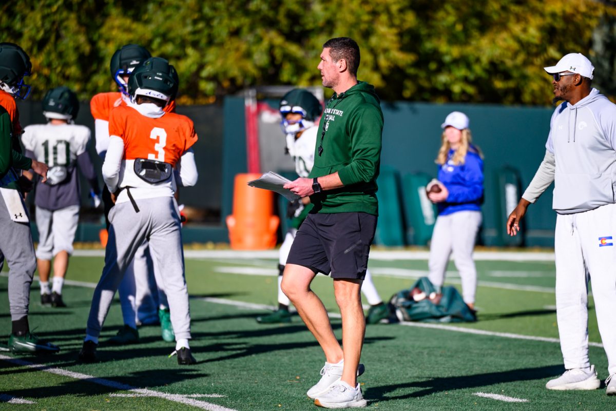 Colorado State University football tight end coach Grant Chesnut walks through players in between drills at football practice Oct. 21.