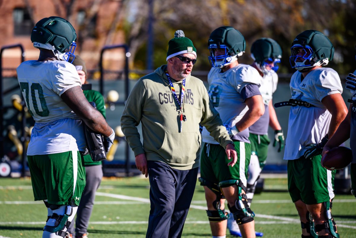 Colorado State University football offensive line coach Bill Best talks to players about their next drill during football practice Oct. 21.