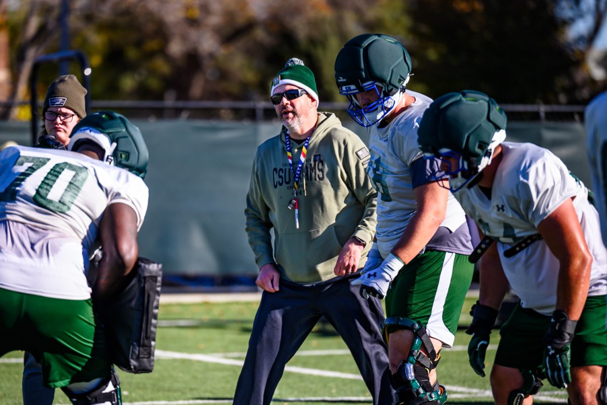 Colorado State University football offensive line coach Bill Best talks to players about their next drill during football practice Oct. 21.